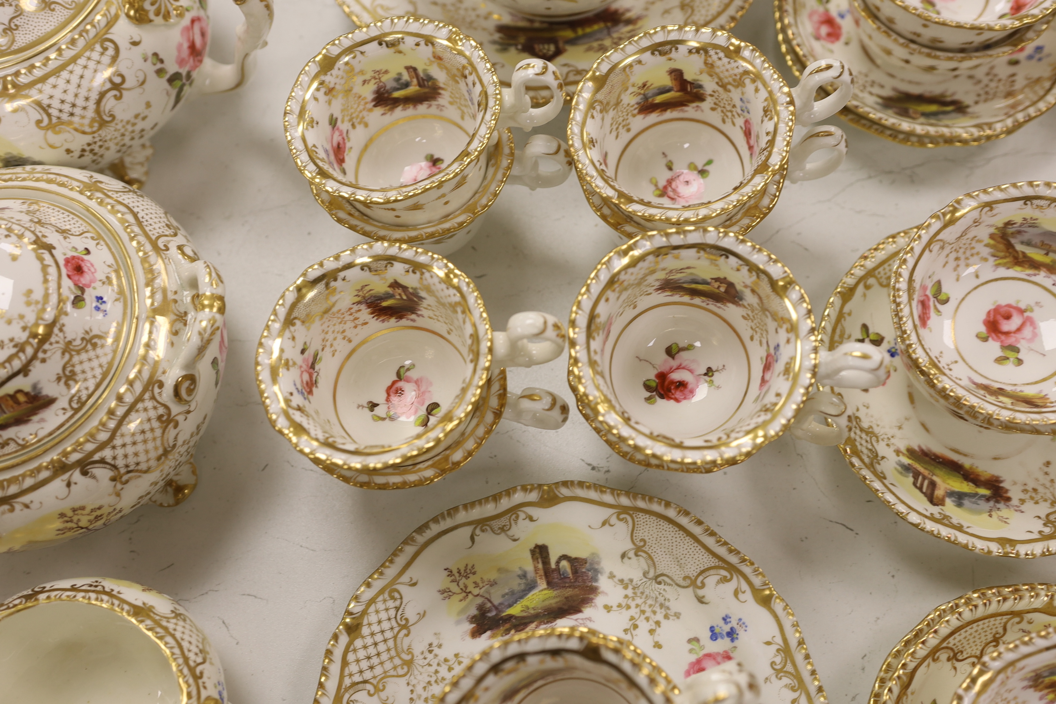 An early 19th century H & R Daniel landscape painted tea and coffee set, including twelve tea cups and saucers, twelve coffee cups, a teapot, a jug and a covered serving bowl, teapot 15cm high